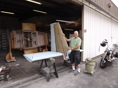 Chuck standing next to the vertical fin and horizontal stabilizer.